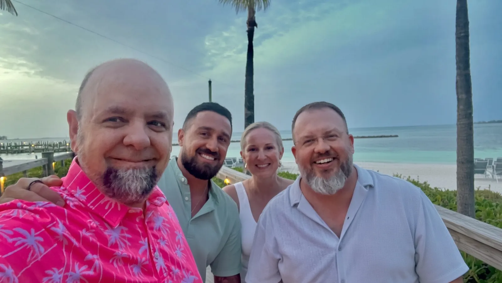 Four members of the BidZone leadership team together by the water